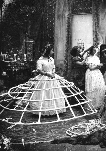 Kristin Holt | Pencil Skirts, Victorian Style. Vintage photograph of a young woman in her petticoats, corset cover, and the widest set of hoop skirts ever! Image: Pinterest.