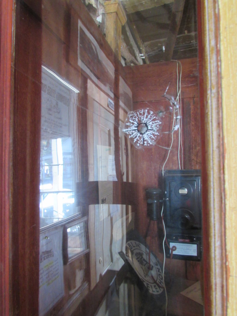Kristin Holt | Historic Idaho Hotel in Silver City. Public phone booth displayed in the hotel lobby sports a bullet hole. Very Wild West!