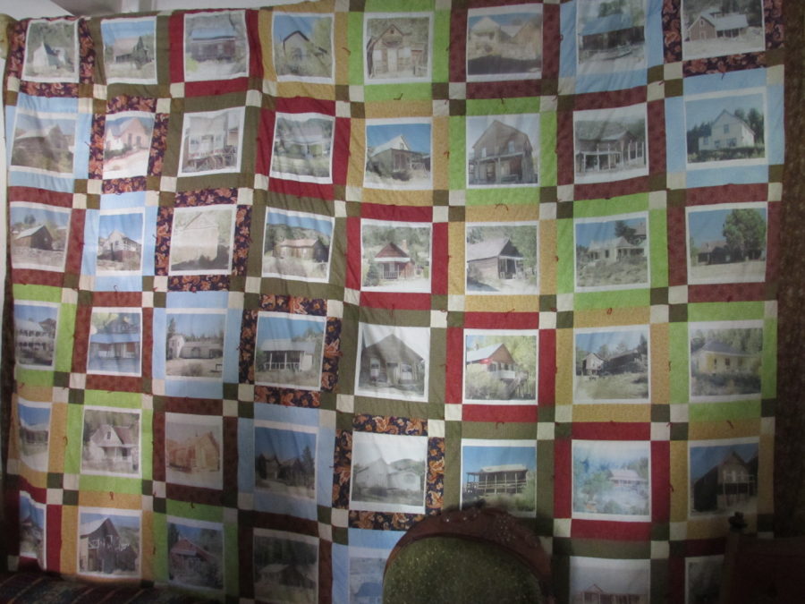 Kristin Holt | Historic Silver City, Idaho. Quilt on display in Ladies Parlor of Idaho Hotel. Each quilt block features a photograph of an historic structure (business, home, church, etc.) in Silver City, Idaho. Photo 2016, Kristin Holt.