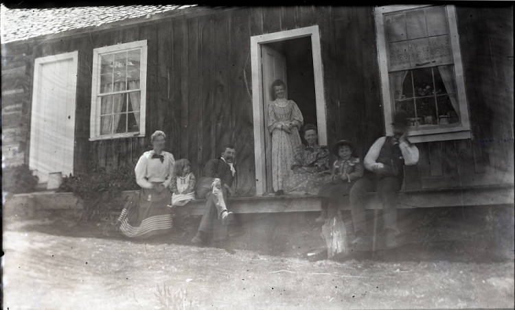 Kristin Holt | Historic Silver City, Idaho. Victorian photograph taken in Silver City by unknown photographer. Unidentified persons sitting on porch of a cabin. Image courtesy of: Idaho State Archives, Idaho State Historical Society. Identifier: P1960-139-11.