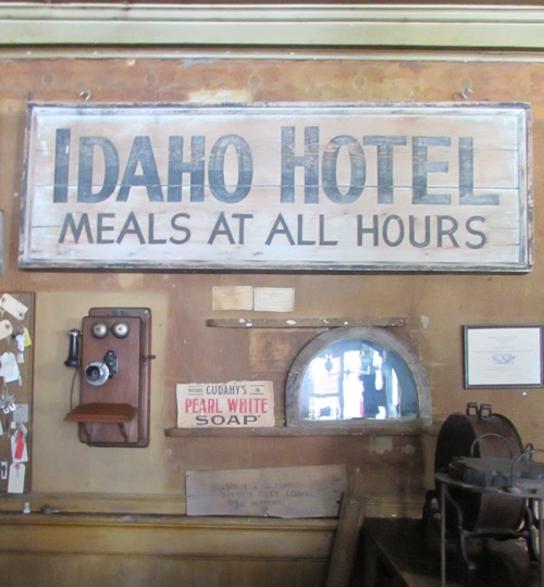 Historic check-in area of the historic Idaho Hotel. The half-circle window was a pass-through into the bar behind for the cashier to deliver money to the bartender. Ladies didn't enter the bar in those days.