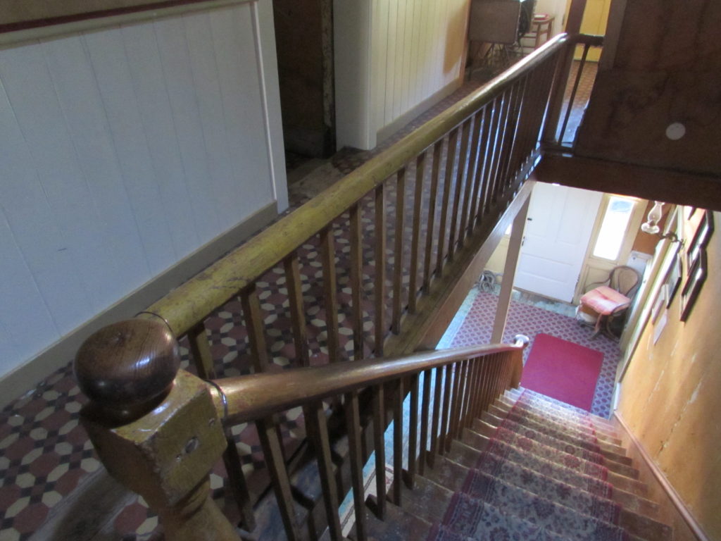Kristin Holt | Historic Idaho Hotel in Silver City. Staircase, as viewed from the second floor landing, outside guest rooms. 