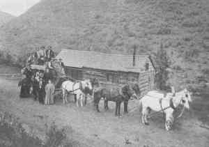 Kristin Holt | Historic Silver City, Idaho. Vintage photograph of a cabin, heavily laden wagon, and six horses. Image courtesy of GhostTown.com.