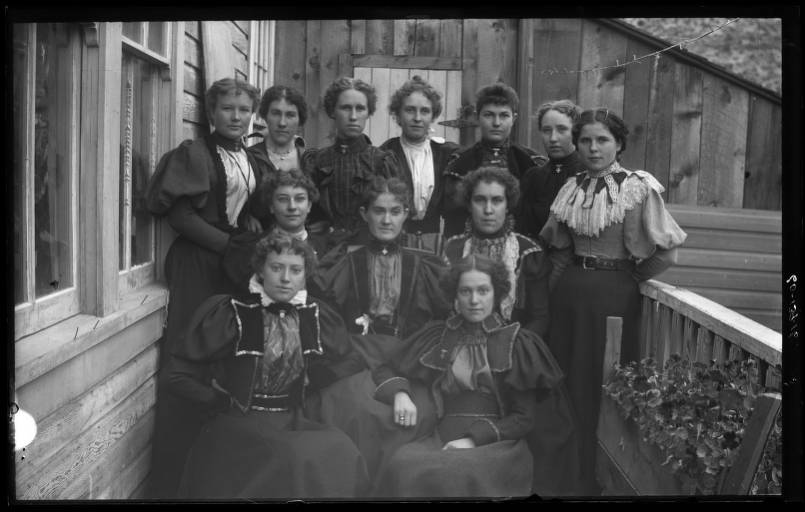 Kristin Holt | Historic Silver City, Idaho. Twelve women posed on a porch in Silver City, Idaho by unknown photographer. Styles indicate 1890s. Image credit: Idaho State Archives, Idaho State Historical Society. Identifier: P1960-139-16.