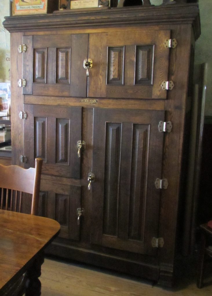 Kristin Holt | Victorian Refrigerators (a.k.a. Icebox).  Photograph of Victorian Industrial Ice Box. This antique resides in Dining Room of Historic Idaho Hotel in Silver City, Idaho. Photo: June 2016, Kristin Holt.