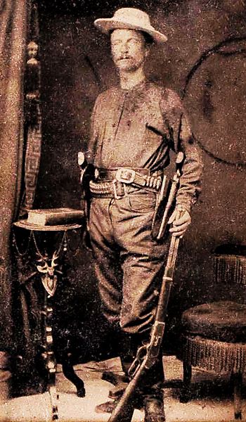 One of the best portraits of a Ranger captain in Ranger attire, this circa 1878 tintype shows Capt. Junius June Peak holding a Winchester 1873 rifle and wearing his two Colt revolvers on holstered cartridge belts, butts forward in cross draw position. X AND Image: Pinterest.