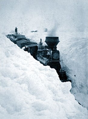 Kristin Holt | Victorian Blizzards, Nonstop in the 1880s. Vintage photograph: a snow blockade in southern Minnesota. On March 29, 1881 snowdrifts in Minesota were higher than locomotives. Photograph by Elmer and Tenney. Public Domain.