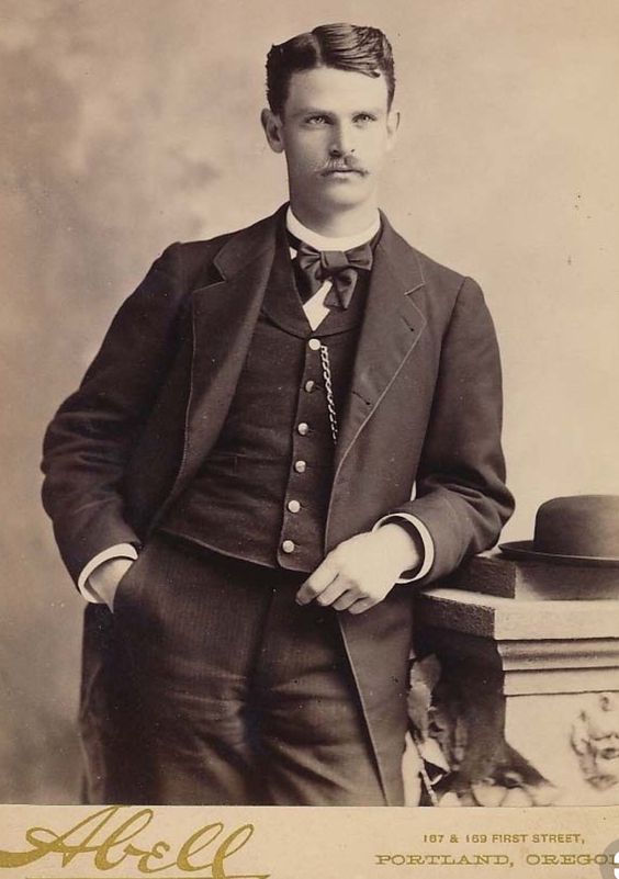 Kristin Holt | Victorian Collars and Cuffs (for men). Vintage photograph of a handsome Victorian man, in his proper suit of clothes, pristine white collar, cuffs, and a small amount of the "bosom" of the shirt visible.