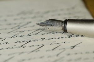 Krisitn Holt | Photograph of fountain pen nib resting upon a handwritten page. Related to Victorian Fountain Pens.