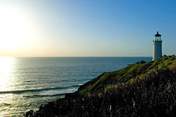 Kristin Holt | Cape Disappointment: Fact and Fiction. Photograph of North Head Light, Cape Disappointment. Perspective shows the sunlit Pacific ocean.