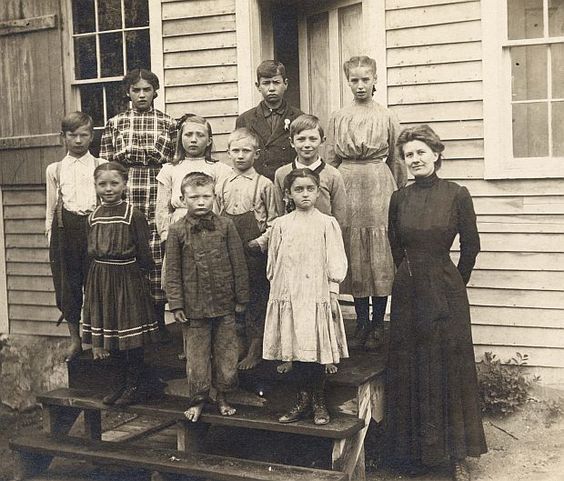 Kristin Holt | Education in the Old West. One Room Schoolhouse, photo of children and teacher on school steps.