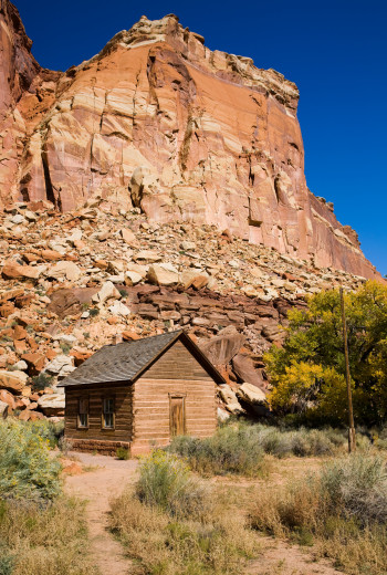 Kristin Holt | Education in the Old West. Image: Early wood pioneer one room schoolhouse in the desert of Capitol Reef National Park, Utah.