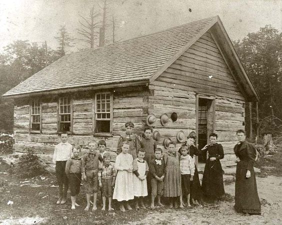 Kristin Holt | Education in the Old West. Image: Teacher with her students outside a log one-room schoolhouse. Image courtesy of Pinterest.