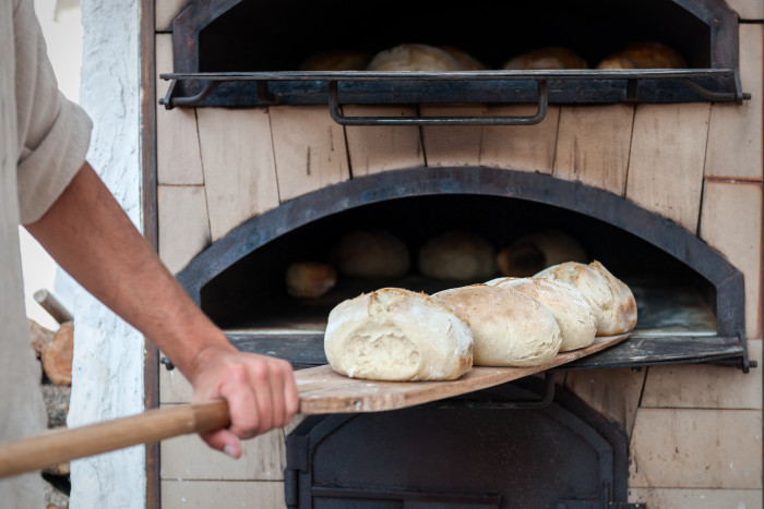 Kristin Holt | Victorian Yeast Bread... Easier After the Centennial. Baker using brick oven to bake bread.