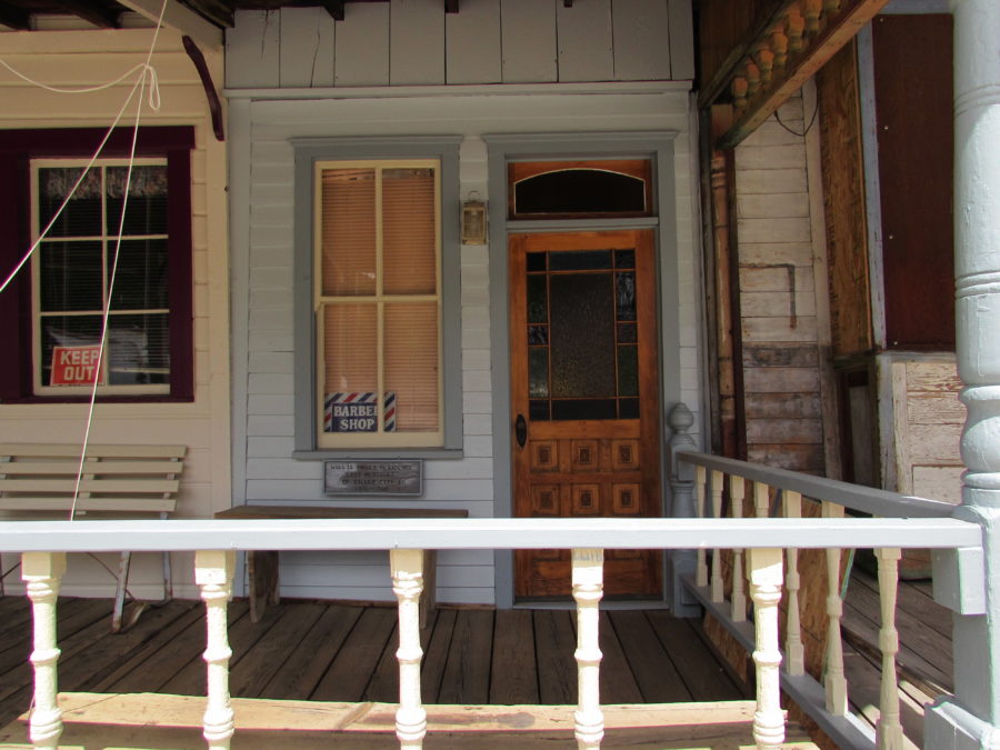 Kristin Holt | Historic Silver City, Idaho. Vintage shop stands in Silver City, with "Barber Shop" sign in window. Look at that gorgeous front door! Photographed by Kristin Holt, 2016.