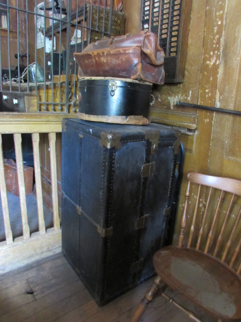 Kristin Holt | Historic Idaho Hotel in Silver City. Vintage travel trunk, hat box, and satchel, on display in the lobby of historic Idaho Hotel, Silver City, Idaho, June 2016.