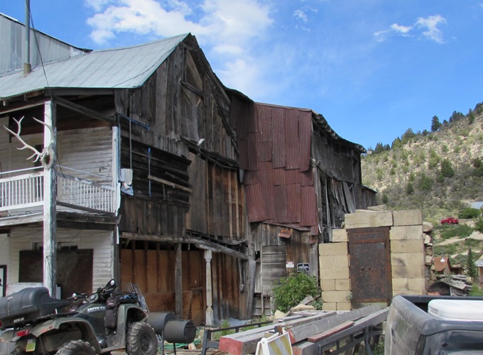 Kristin Holt | Historic Idaho Hotel in Silver City. Contemporary Photo: The stone block Wells Fargo vault with rusted metal door (lower right) within buildings now missing from the original structures. Note: the saloon (1872) formerly attached to this side of the historic Idaho Hotel collapsed beneath the heavy snowfall of the 2004 winter season.