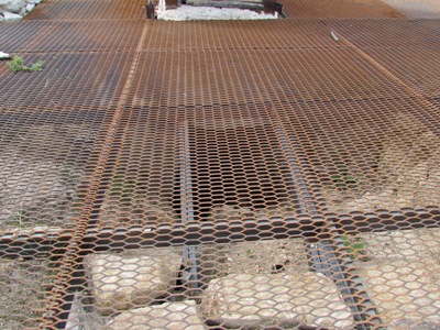 Kristin Holt | Historic Silver City, Idaho. Note the open pit beneath the grating (to protect people from falling into the mining shaft). The mountainside surrounding (and within city limits) Silver City is riddled with mines. Image: 2016, taken by Kristin Holt.