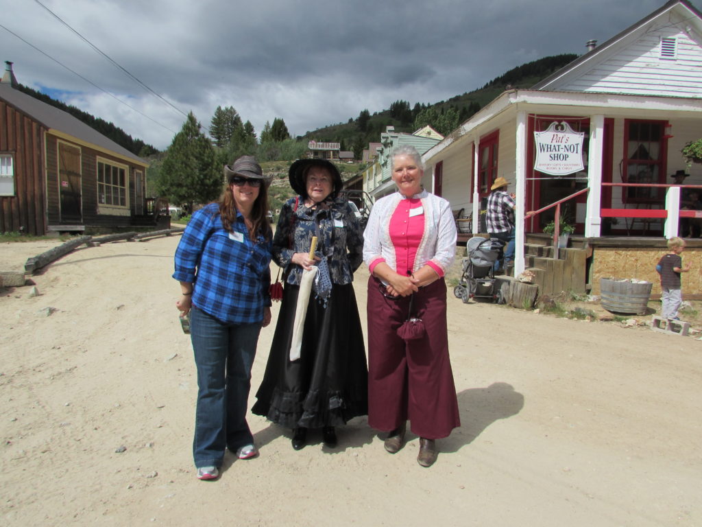 Kristin holt | Historic Idaho Hotel in Silver City. Authors: Ann Charles, Charlene Raddon, and Paty Jager, standing in the street [Washington Street, Silver City, Idaho] (photographer's back is to the hotel).