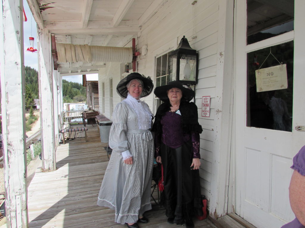 Kristin Holt | Historic Idaho Hotel in Silver City. Kristin Holt (left) and Charlene Raddon (right) [we are both authors of western historical romance], dressed in Victorian-era clothing, on the porch of the Historic Idaho Hotel, Silver City, Idaho.