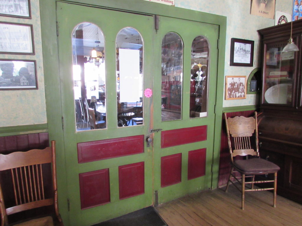 Kristin Holt | Historic Idaho Hotel in Silver City. Vintage, antique double doors (as viewed from the bar/dining room), separating the lobby from the dining room. Historic Idaho Hotel, Silver City, Idaho.