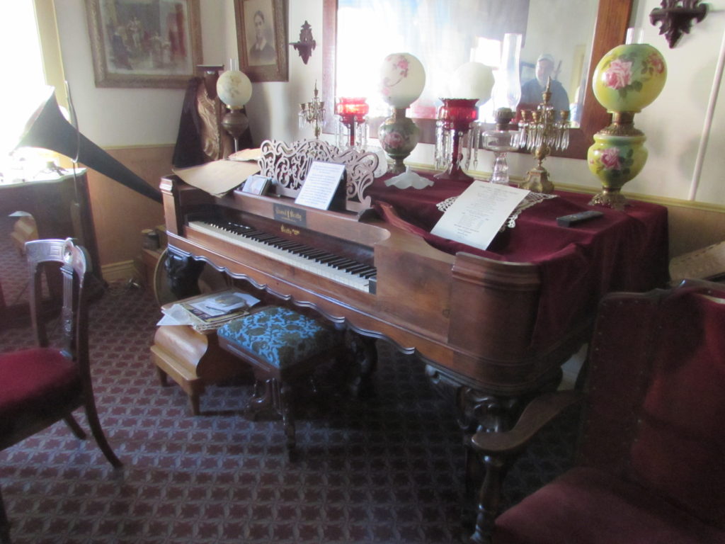 Kristin Holt | Historic Idaho Hotel in Silver City. Antique piano and other decor in the Ladies' Parlor, a room generally closed to the public within the Idaho Hotel.