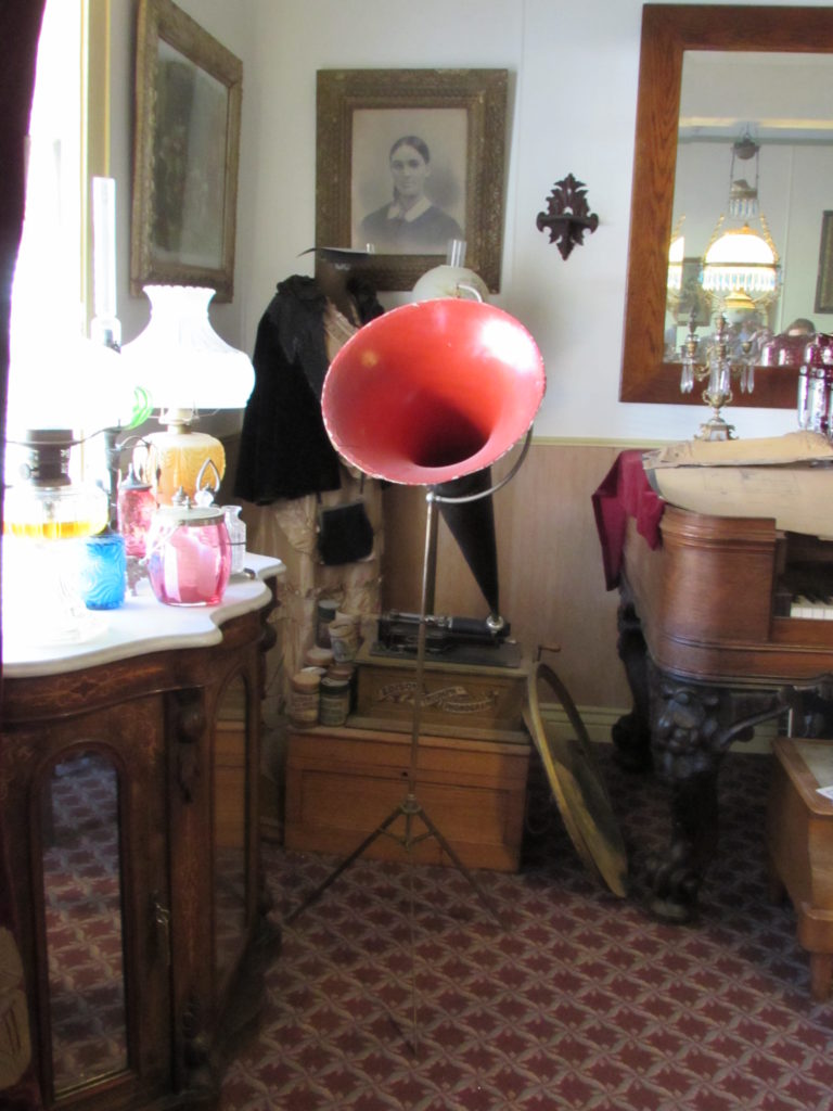 Kristin Holt | Historic Idaho Hotel in Silver City. Edison Triumph Phonograph, on display in the Ladies' Parlor, historic Idaho Hotel of Silver City, Idaho. Note the rolls stacked on the wooden case.