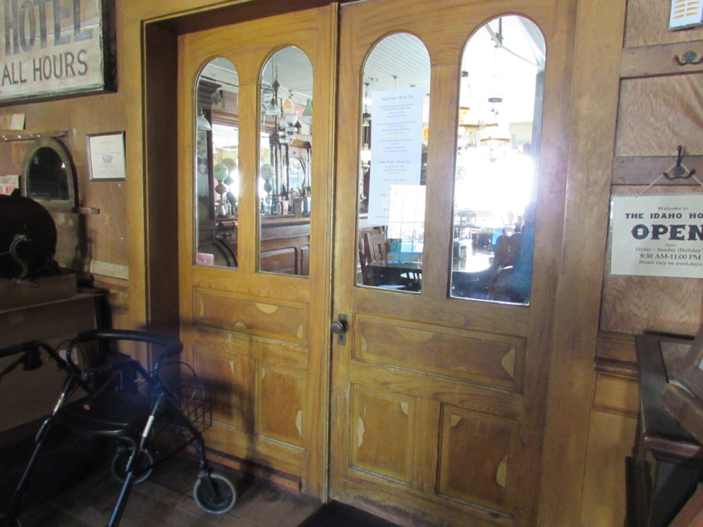 Kristin Holt | Historic Idaho Hotel in Silver City. Vintage, antique double doors separating lobby from the dining room/bar. This natural-wood (rather than painted) side, as viewed from the lobby.
