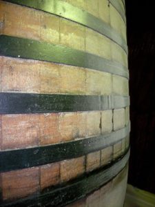 Kristin Holt | Victorian Americans Celebrated Oktoberfest. Photograph: an artistic up-colose view of a wooden cask and iron(?) bands.