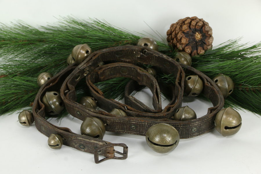 Kristin Holt | How to Conduct a Victorian Sleigh Ride. Photograph of Victorian Antique Brass Sleigh Bells mounted on an 88-inch leather harness belt that is 1.25-inches wide. Bells range from 1.25-inches to 2.25-inches. Sold by The Harp Gallery.