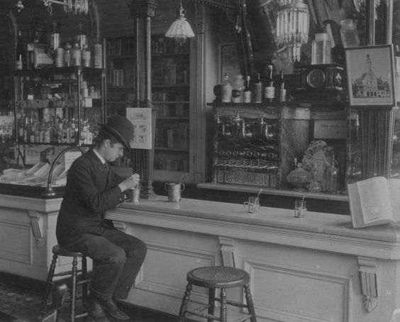 Kristin Holt | The Victorian-era Soda Fountain. Black and white vintage photograph: Soda Fountain inside Vogelsang's Drugstore, 1895, Chicago. Image Courtesy of Pinterest.